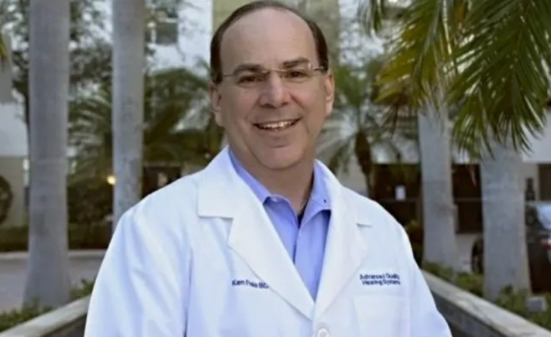 a man with eyeglasses wearing a white lab coat